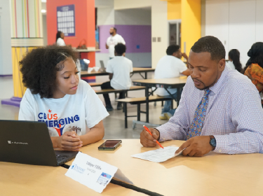  student and teacher reviewing homework